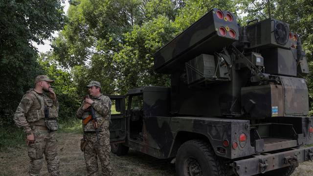 Ukrainian servicemen stand next to an AN/TWQ-1 Avenger mobile air defence missile system outside of Kyiv