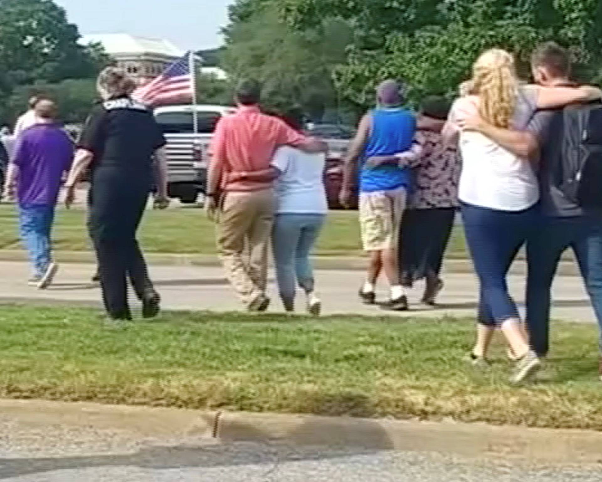 Evacuees walk away from a building in this still image taken from video following a shooting incident at the municipal center in Virginia Beach