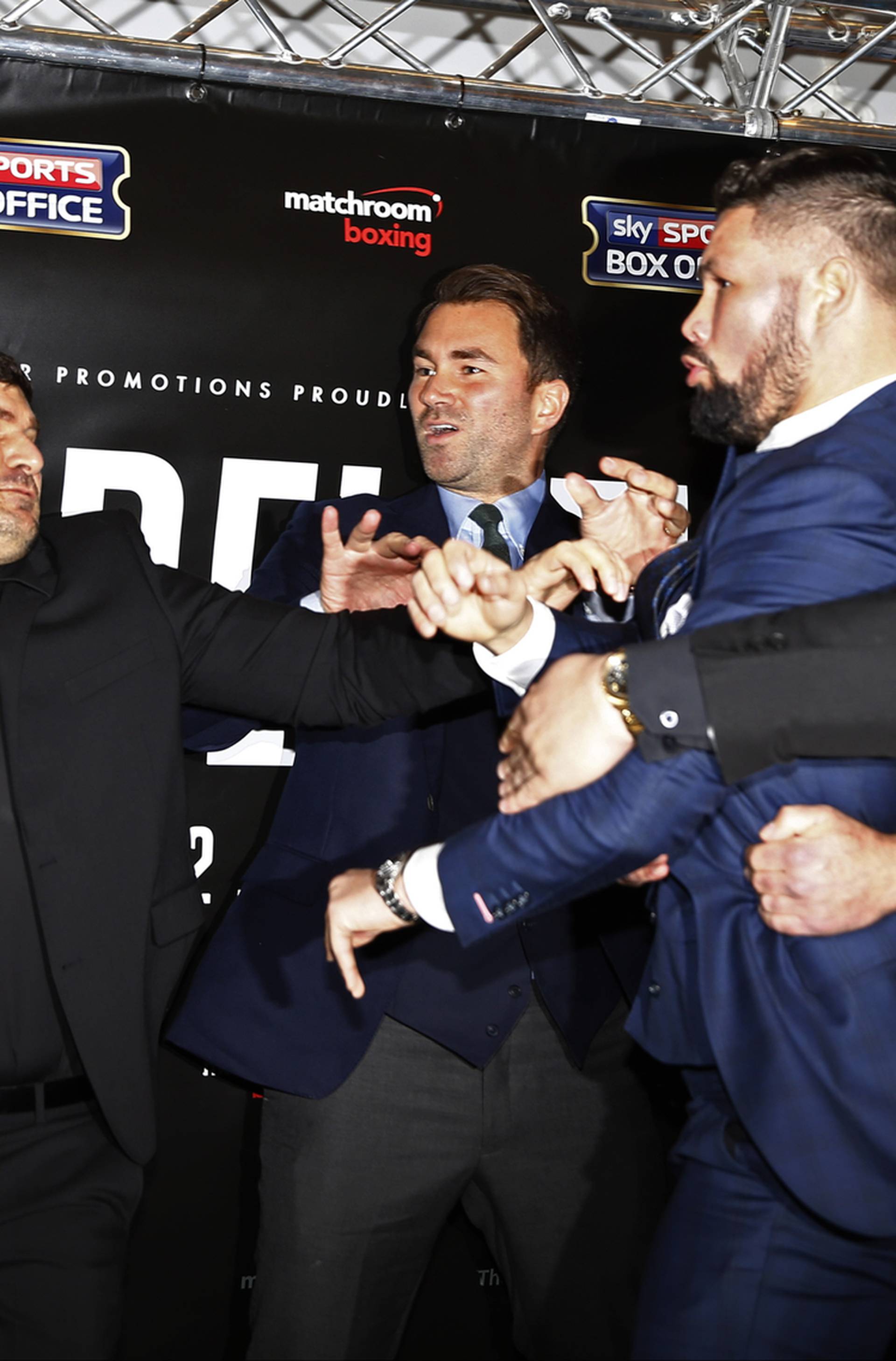 David Haye and Tony Bellew clash after the press conference as promoter Eddie Hearn looks on