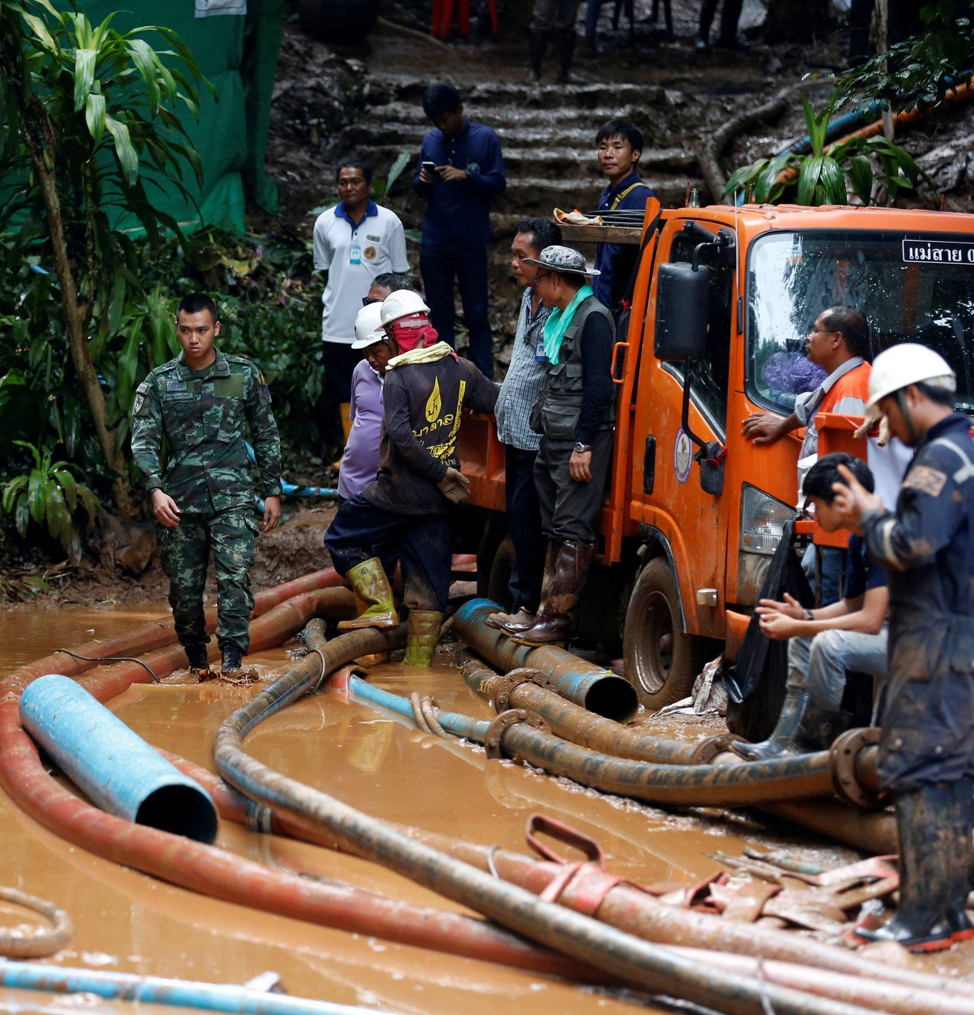 Soldiers and rescue workers work near Tham Luang cave complex, as an ongoing search for members of an under-16 soccer team and their coach continues, in the northern province of Chiang Rai