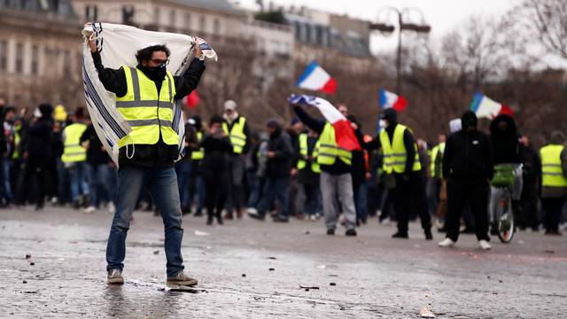 Protesters wearing yellow vests take part in a demonstration by the "yellow vests" movement near the Arc de Triomphe in Paris