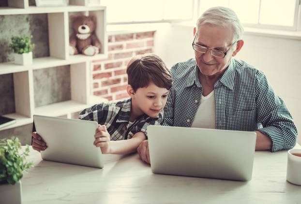 Handsome,Grandpa,And,Grandson,Are,Using,Gadgets,And,Smiling,While