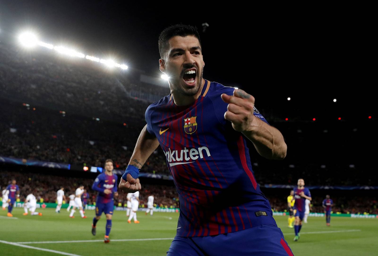 FILE PHOTO: Barcelona's Luis Suarez celebrates scoring their fourth goal in a 4-1 victory over Italy's AS Roma in the first leg of their Champions League quarter-final tie.