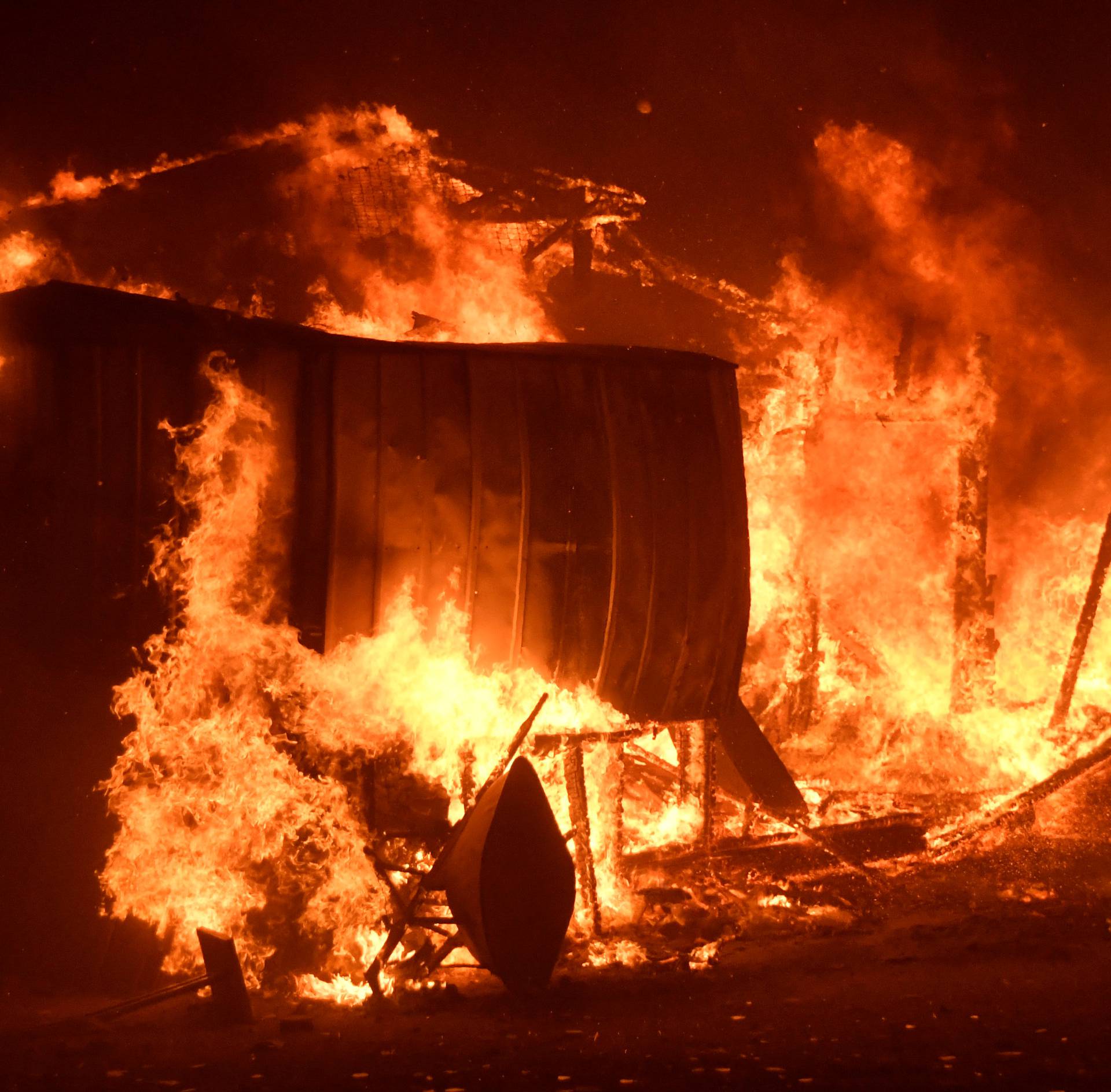 Structures burn in an early-morning Creek Fire that broke out in the Kagel Canyon area in the San Fernando Valley north of Los Angeles