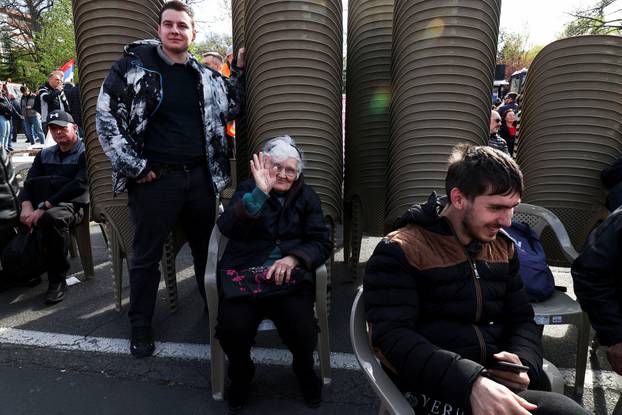 People attend a rally in support of policies of the President Aleksandar Vucic