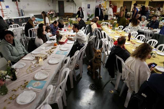 Israelis hold a Passover Seder in an underground parking garage used as a public bomb shelter, in Tel Aviv