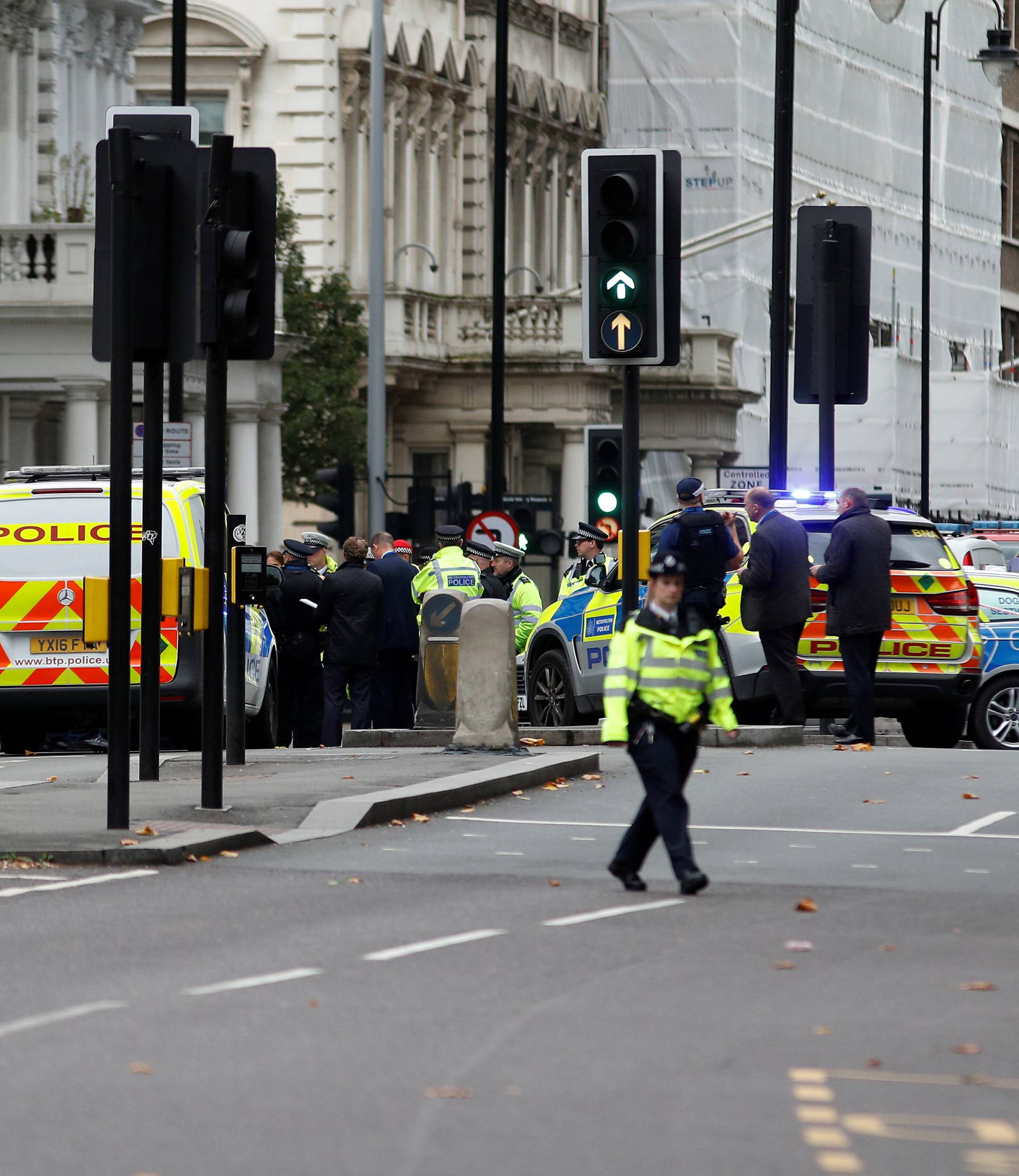 Police officers stand in the road outside the Natural History Museum, after a car mounted the pavement injuring a number of pedestrians, in London