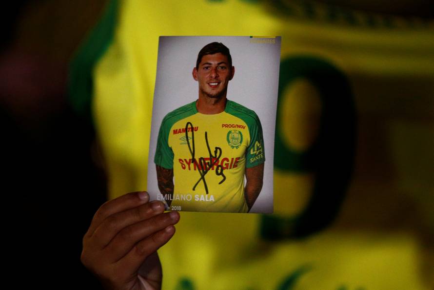 A fan holds a portrait of Emiliano Sala in Nantes' city center after news that newly-signed Cardiff City soccer player Emiliano Sala was missing after the light aircraft he was travelling in disappeared between France and England