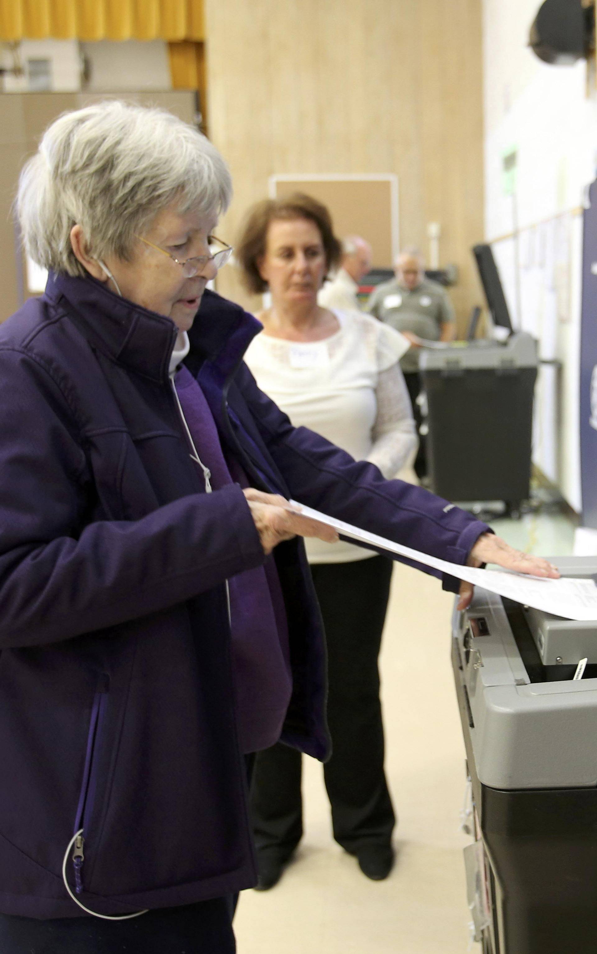 Susan Novak scans her ballots after voting during the U.S. presidential election in Ohio