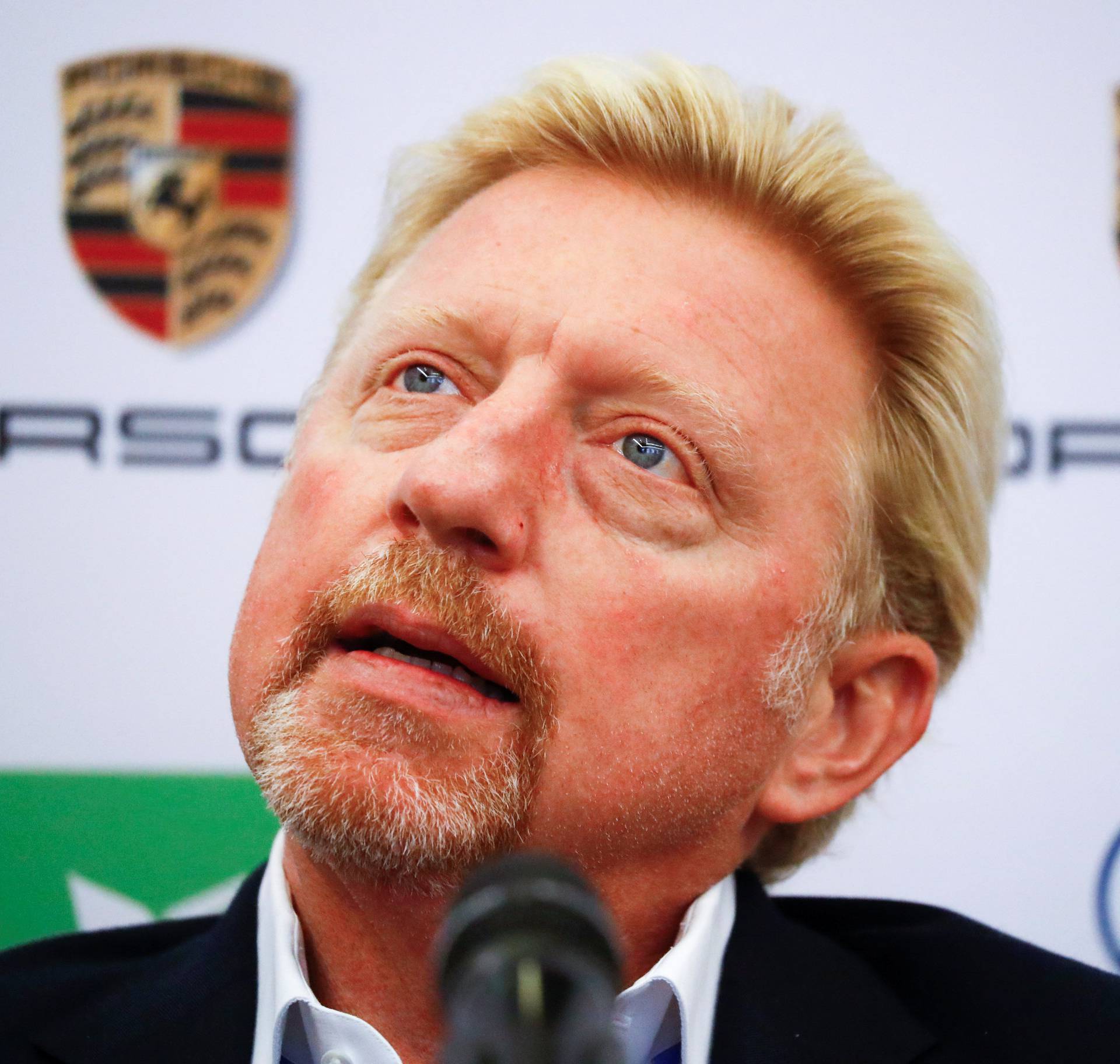 Three-times Wimbledon champion Boris Becker reacts as he is announced as German Tennis Federation's new head of men's tennis during a news conference in Frankfurt