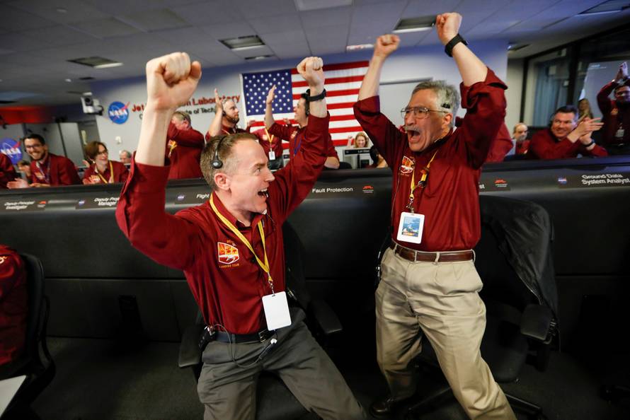 NASA engineers Kris Bruvold and Sandy Krasner react in the space flight operation facility at NASA's Jet Propulsion Laboratory (JPL) as the spaceship InSight lands on the surface of Mars after a six-month journey, at JPL in Pasadena