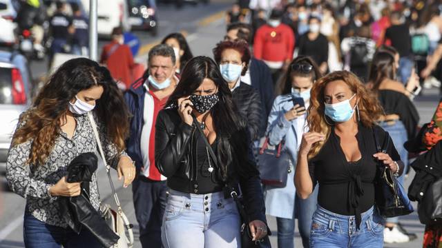 People wear face masks after the southern Italian region of Campania made it mandatory to wear protective face coverings outdoors 24 hours a day, to contain the coronavirus disease (COVID-19) outbreak