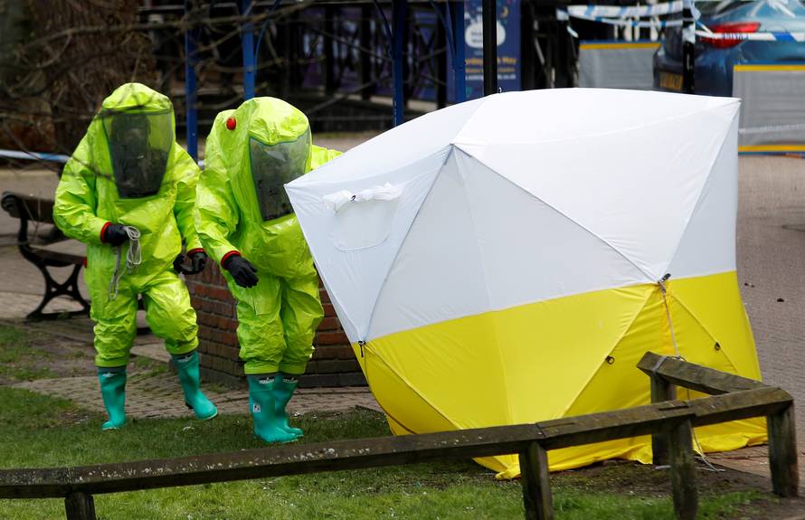 FILE PHOTO: The forensic tent, covering the bench where Sergei Skripal and his daughter Yulia were found, is repositioned by officials in protective suits in the centre of Salisbury