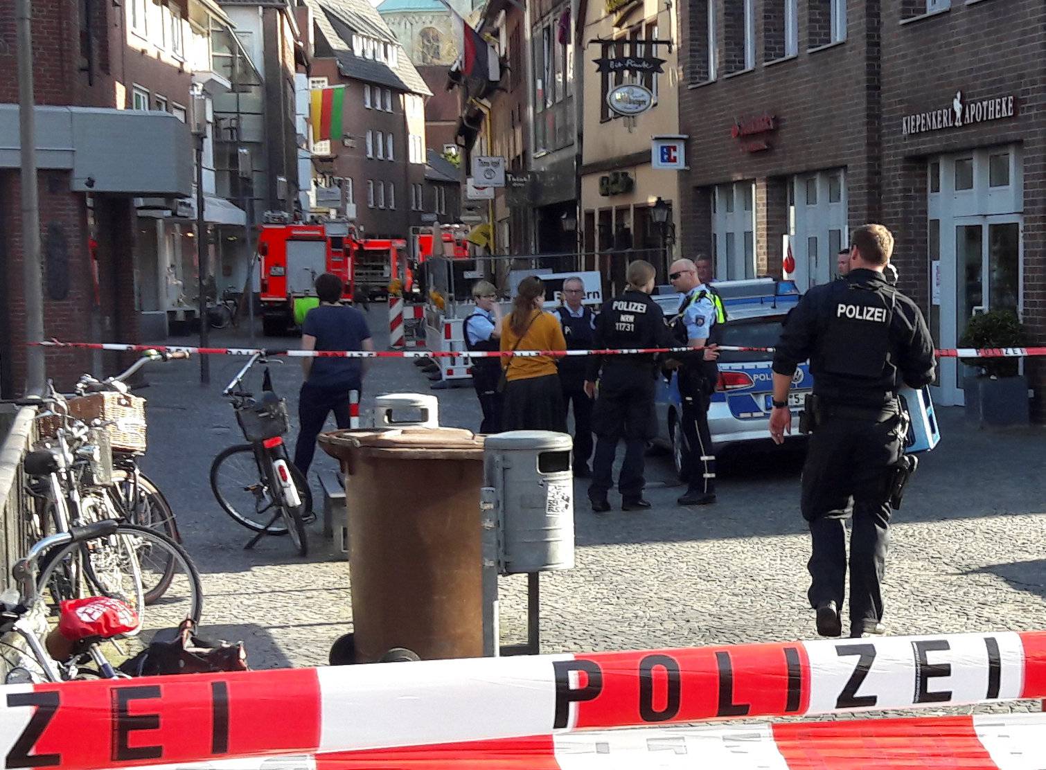 Police block a street near a place where a man drove a van into a group of people sitting outside a popular restaurant in the old city centre of Muenster