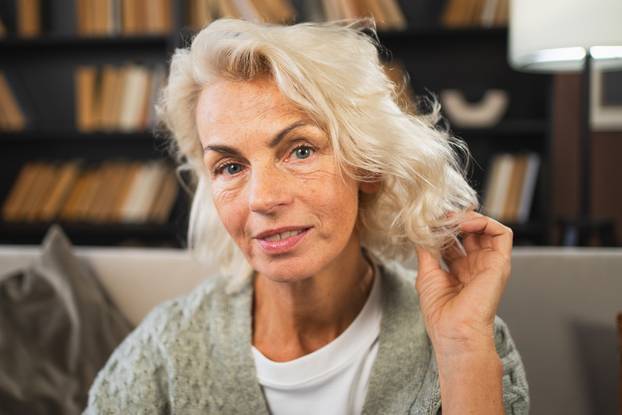 Portrait of confident stylish European middle aged senior woman. Older mature 60s lady smiling at home. Happy attractive senior female looking camera close up face headshot portrait. Happy people.