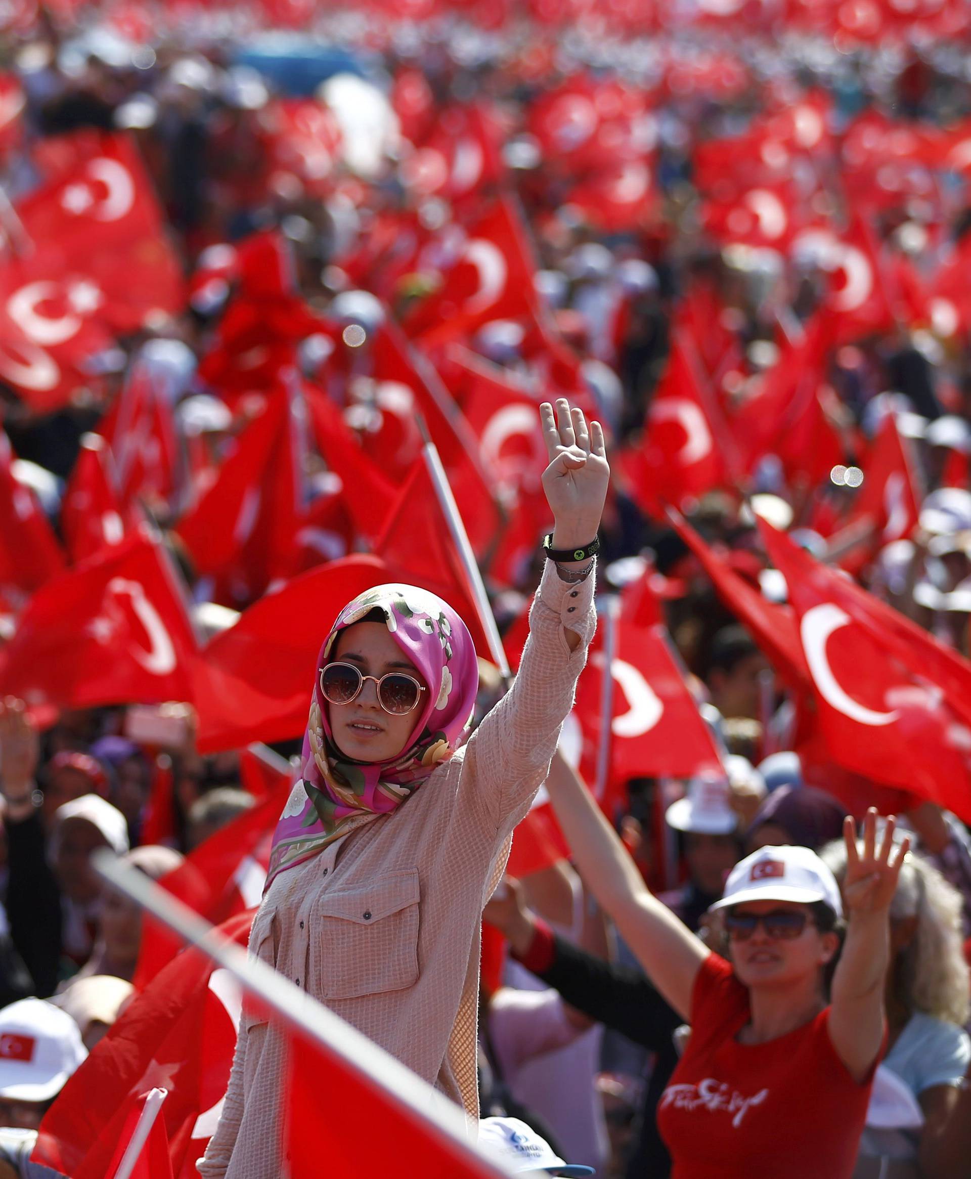 A woman reacts as she attends the Democracy and Martyrs Rally in Istanbul