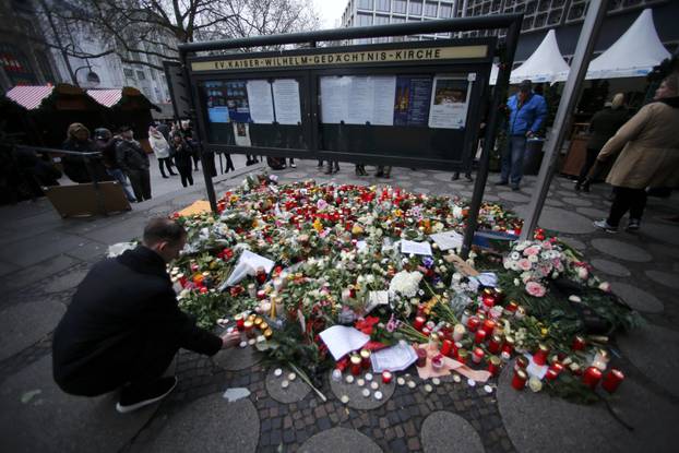 Flowers and candles are placed near the Christmas market in Berlin