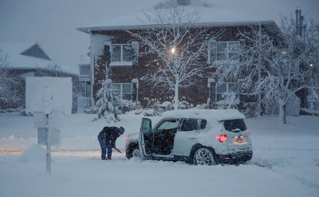 Woman shovels snow in Arlington Heights