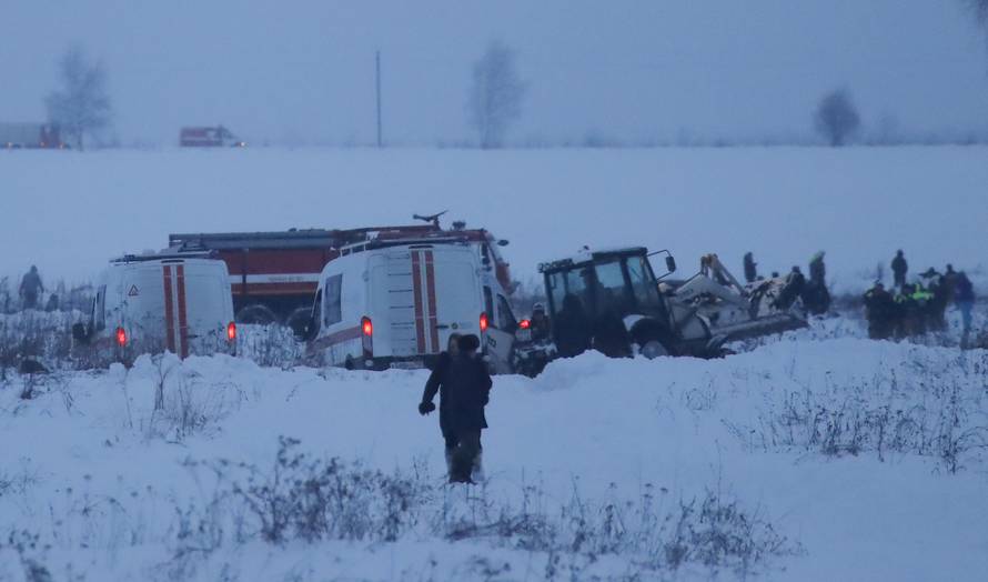 Emergency services work at the scene where a short-haul regional Antonov AN-148 plane crashed after taking off from Moscow's Domodedovo airport, outside Moscow