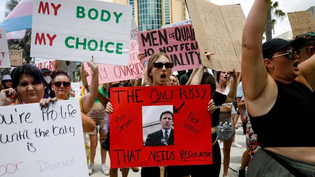 Abortion rights activists protest outside the venue of a summit by the conservative group Moms For Liberty in Tampa