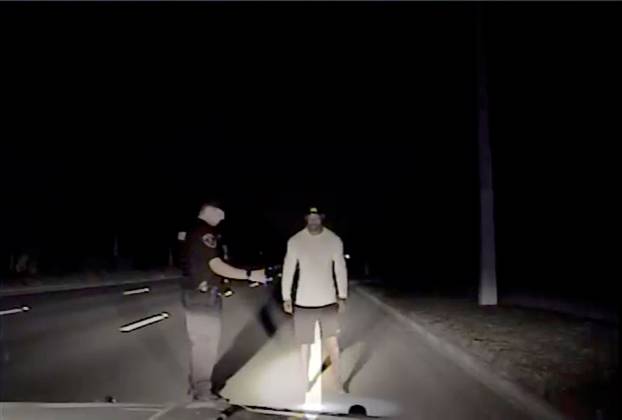 Tiger Woods is seen performing field sobriety tests following orders from a police officer in this still image from police dashcam video in Jupiter