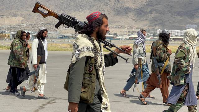 FILE PHOTO: Taliban forces patrol at a runway a day after U.S troops withdrawal from Hamid Karzai International Airport in Kabul