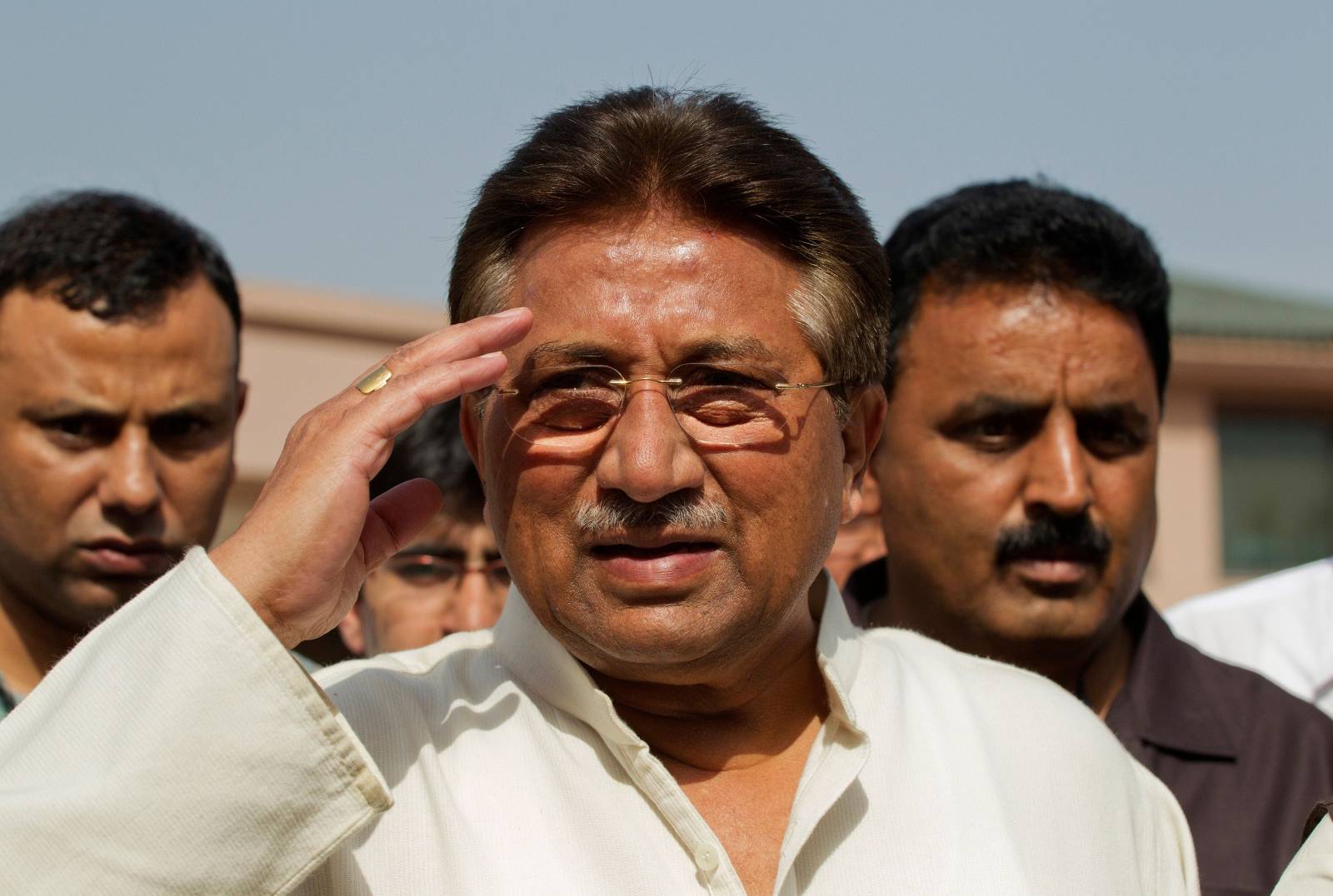 FILE PHOTO: Pakistan's former President Musharraf salutes as he arrives to unveil his party manifesto for the forthcoming general election at his residence in Islamabad