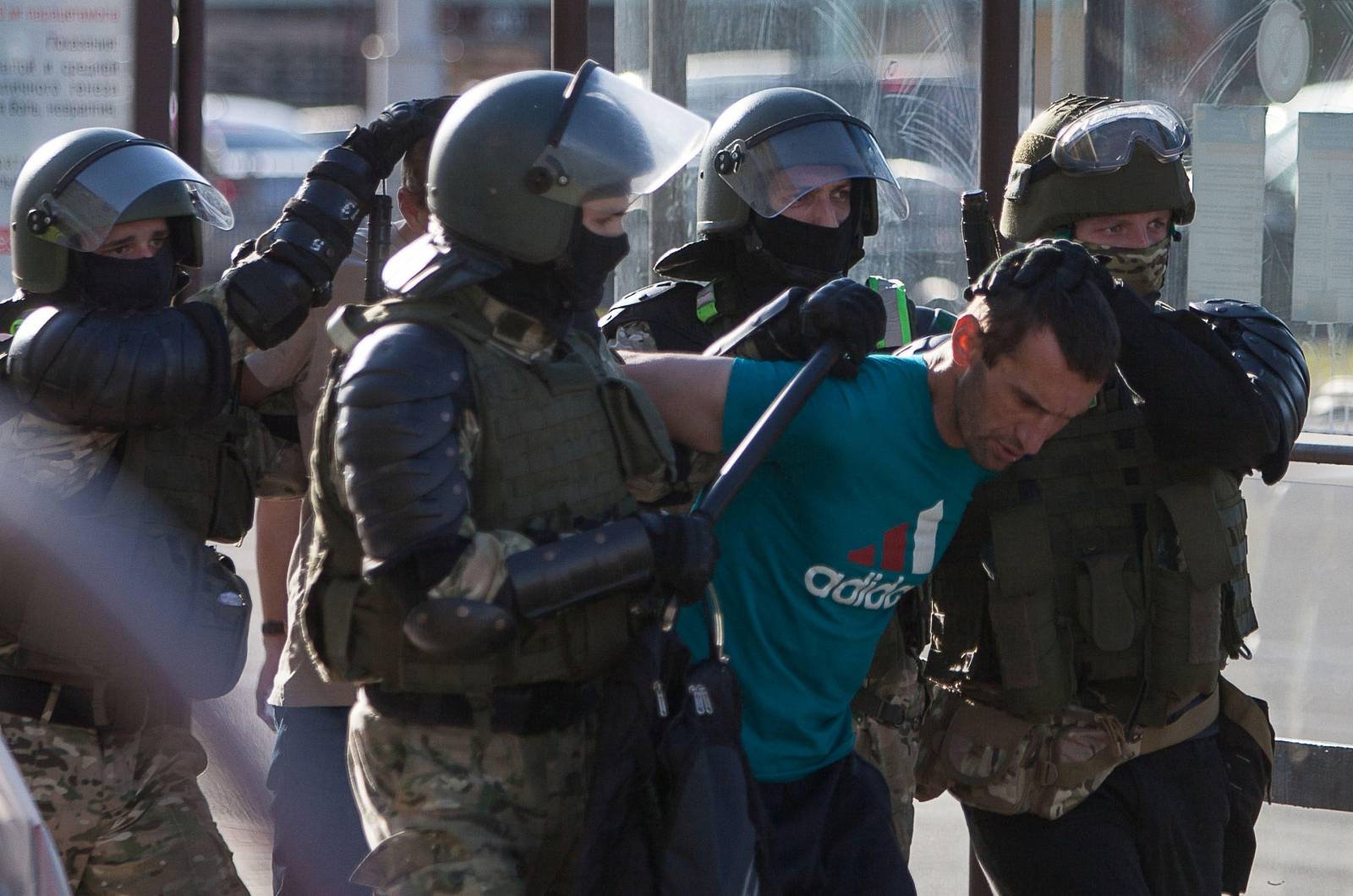 Law enforcement officers detain a man near the site where a protester died during a rally following the presidential election in Minsk