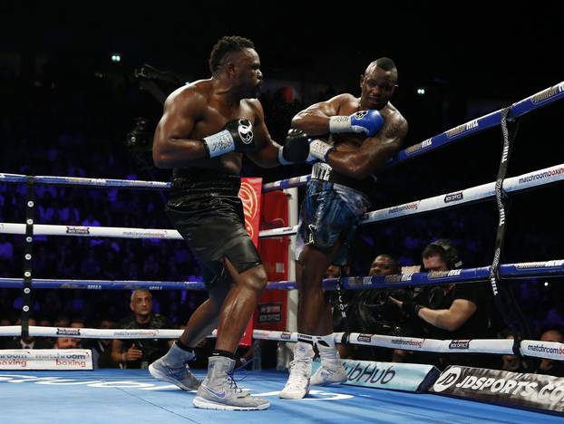 Dereck Chisora in action against Dillian Whyte (R)