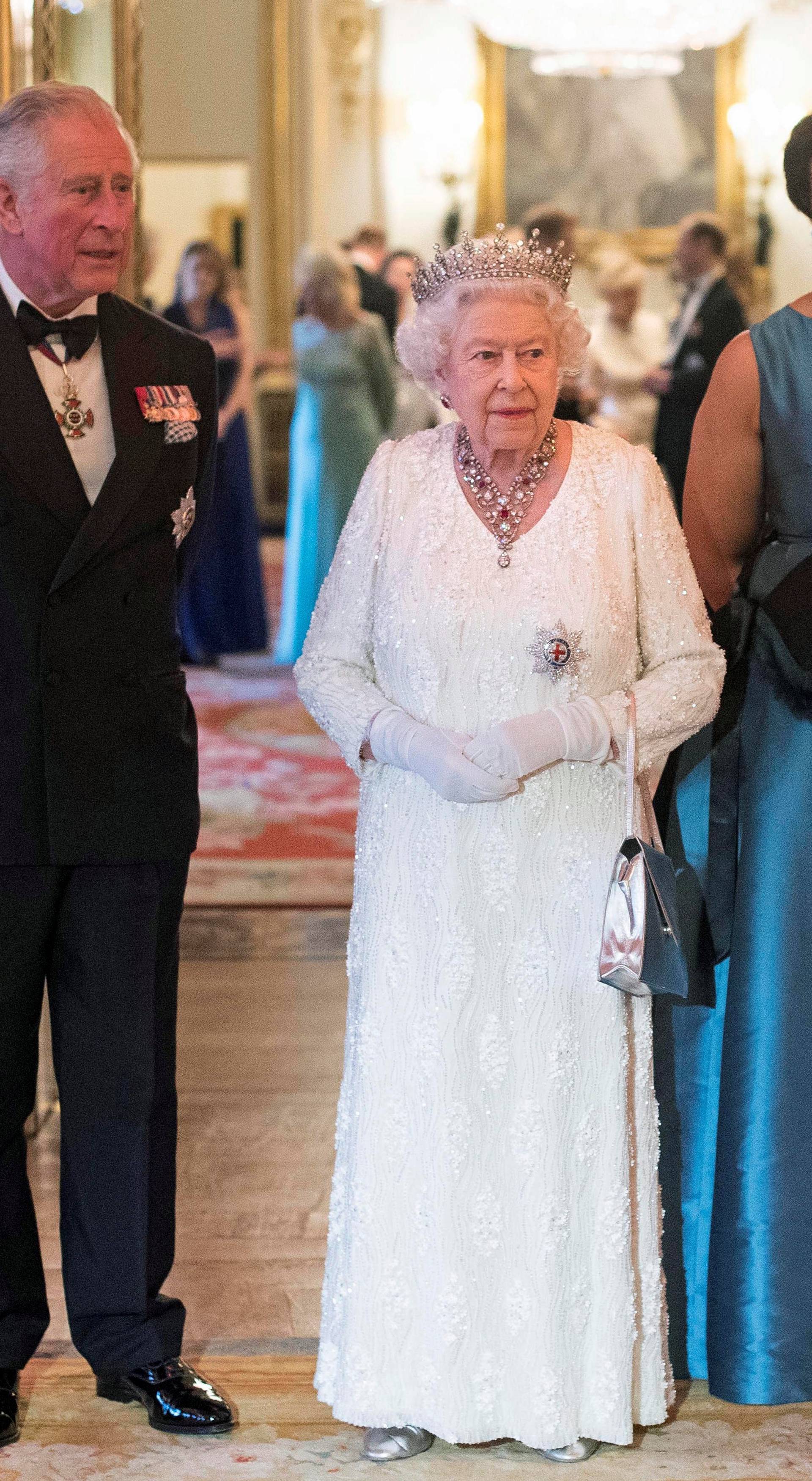 Britain's Queen Elizabeth and Prince Charles pose in the Blue Drawing Room at Buckingham Palace as the Queen hosts a dinner during the Commonwealth Heads of Government Meeting in London