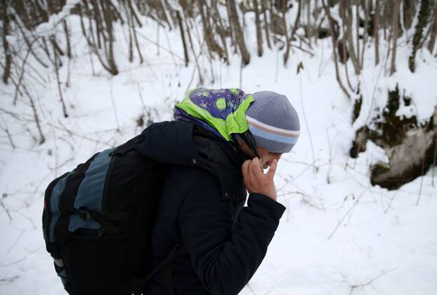 A migrant attempts to illegally cross the border into Croatia on the Pljesevica Mountain near Bihac