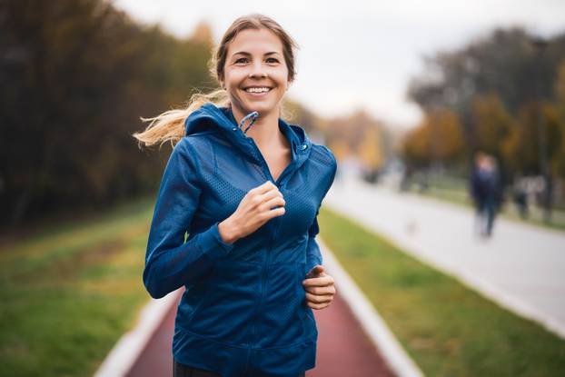 Beautiful,Adult,Woman,Is,Jogging,Outdoor,On,Cloudy,Day,In