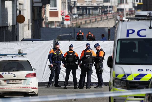 Police secure the site near a synagogue damaged by an explosion in Liege