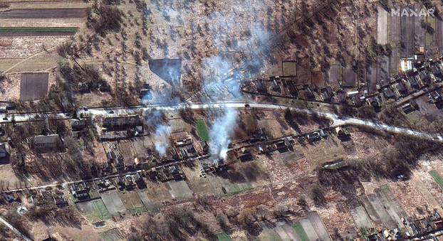 A satellite image shows part of a military convoy and burning homes, near Invankiv