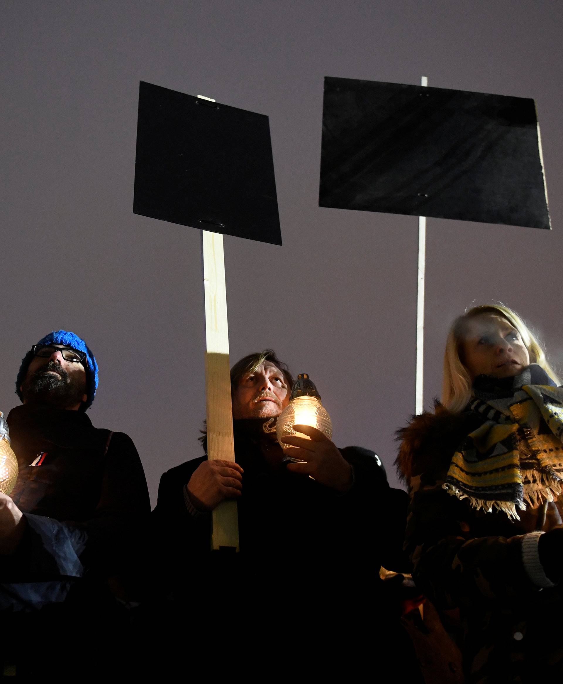 Participants hold candles during a march in honour of murdered Slovak investigative reporter Jan Kuciak