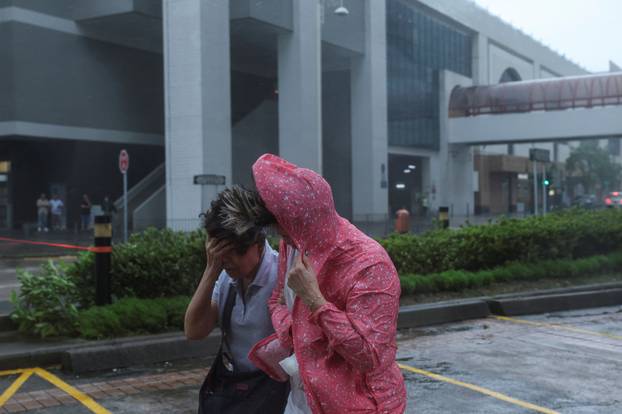 People brave strong winds as Typhoon Wipha approaches, in Hong Kong