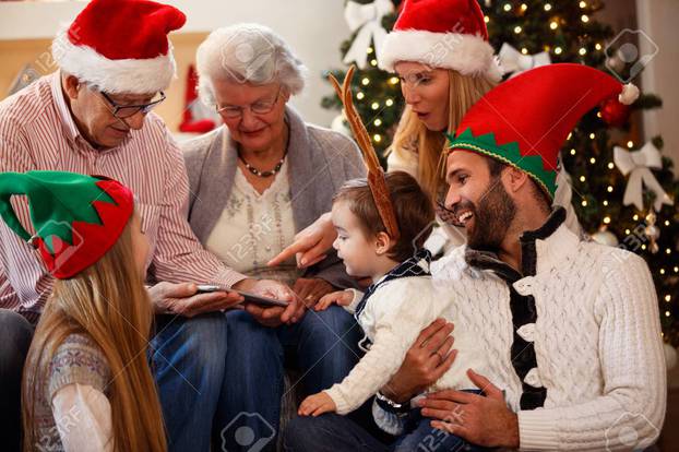 family is spending time together on Christmas day and using tabl