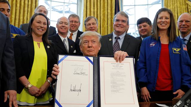 Trump signs NASA act at the White House in Washington