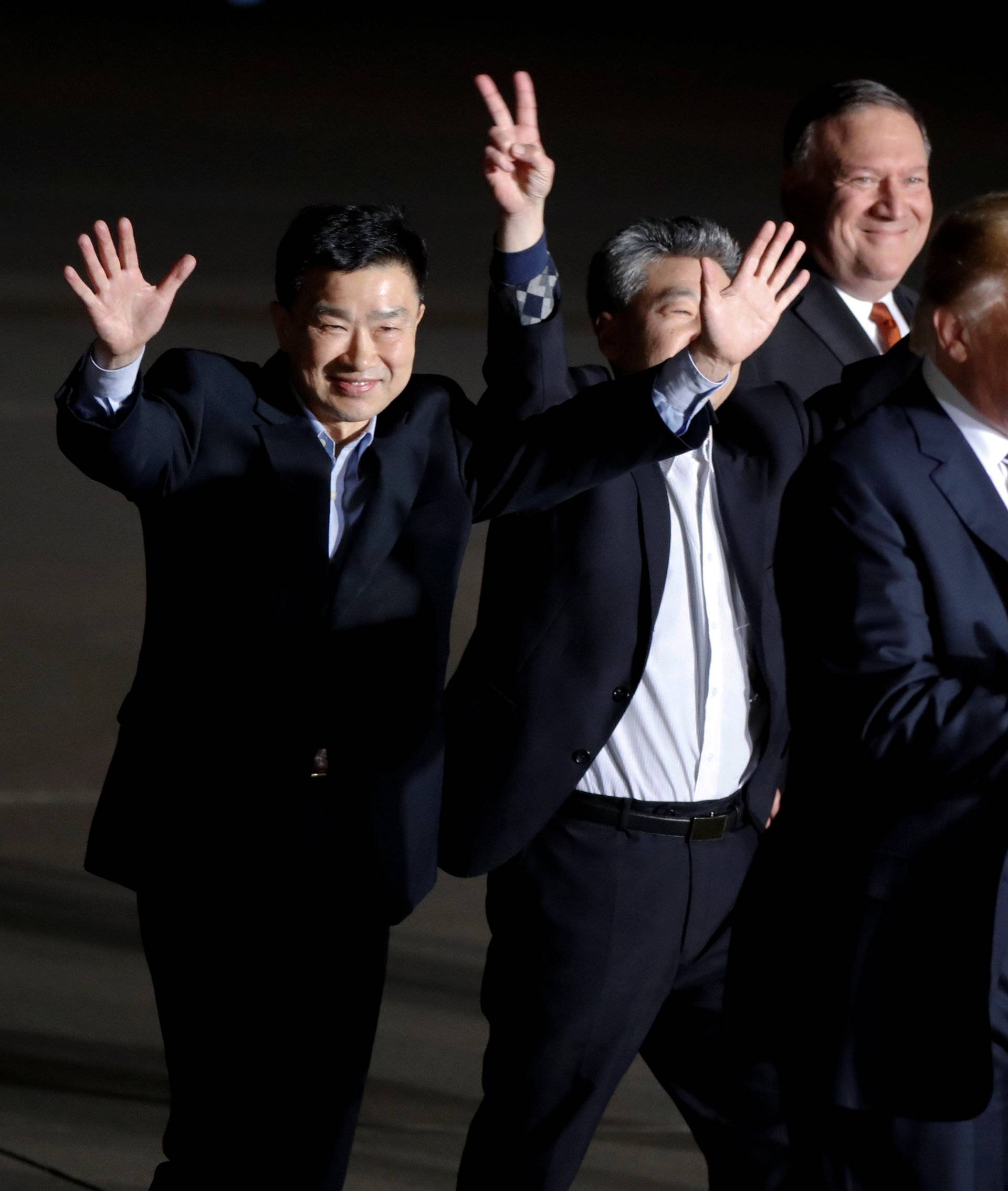 The three Americans formerly held hostage in North Korea gesture next to U.S.President Donald Trump and Secretary of State Mike Pompeo, upon their arrival at Joint Base Andrews