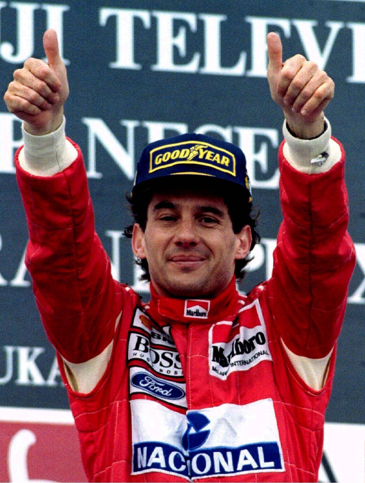 FILE PHOTO: Senna of Brazil gestures to the crowd after winning the Suzuka Grand Prix in Japan