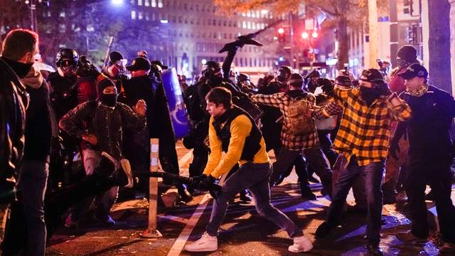 Members of the far-right group Proud Boys clash with counter protesters, in downtown Washington