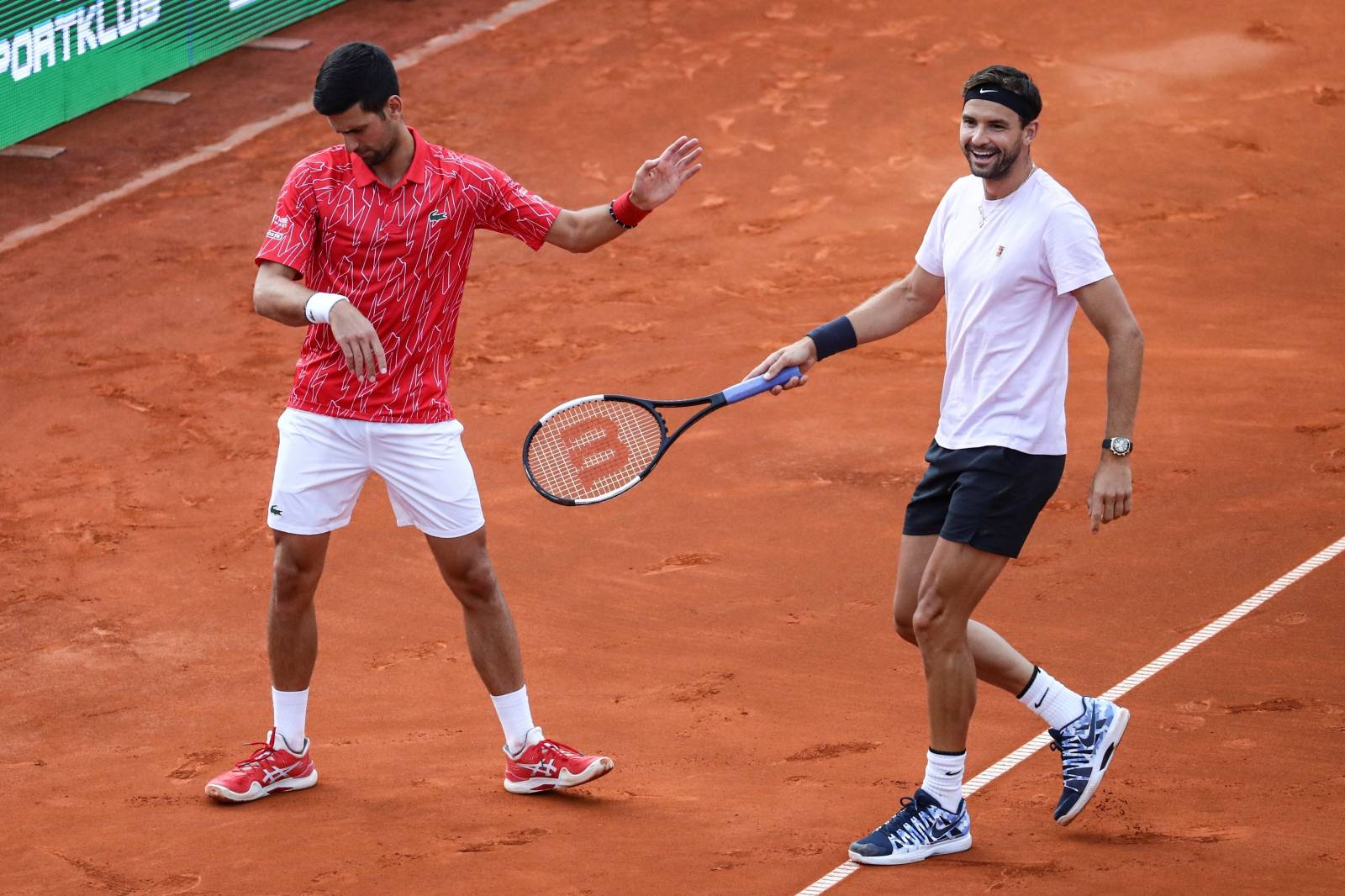 Serbia's Novak Djokovic with Bulgaria's Grigor Dimitrov during their doubles match during Adria Tour at Novak Tennis Centre in Belgrade