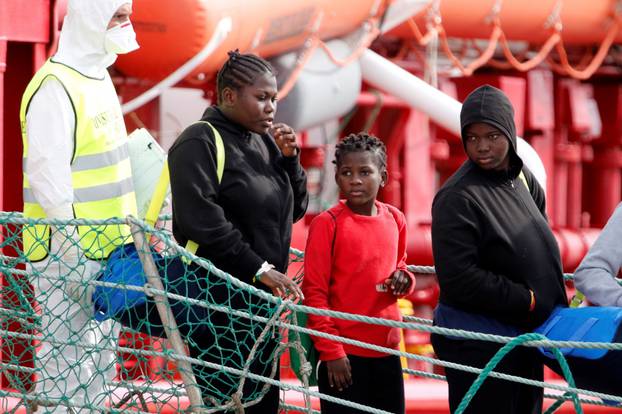 Migrants disembark at the port of Pozzallo after spending nearly two weeks on board the Medecins Sans Frontieres (MSF)-operated Ocean Viking