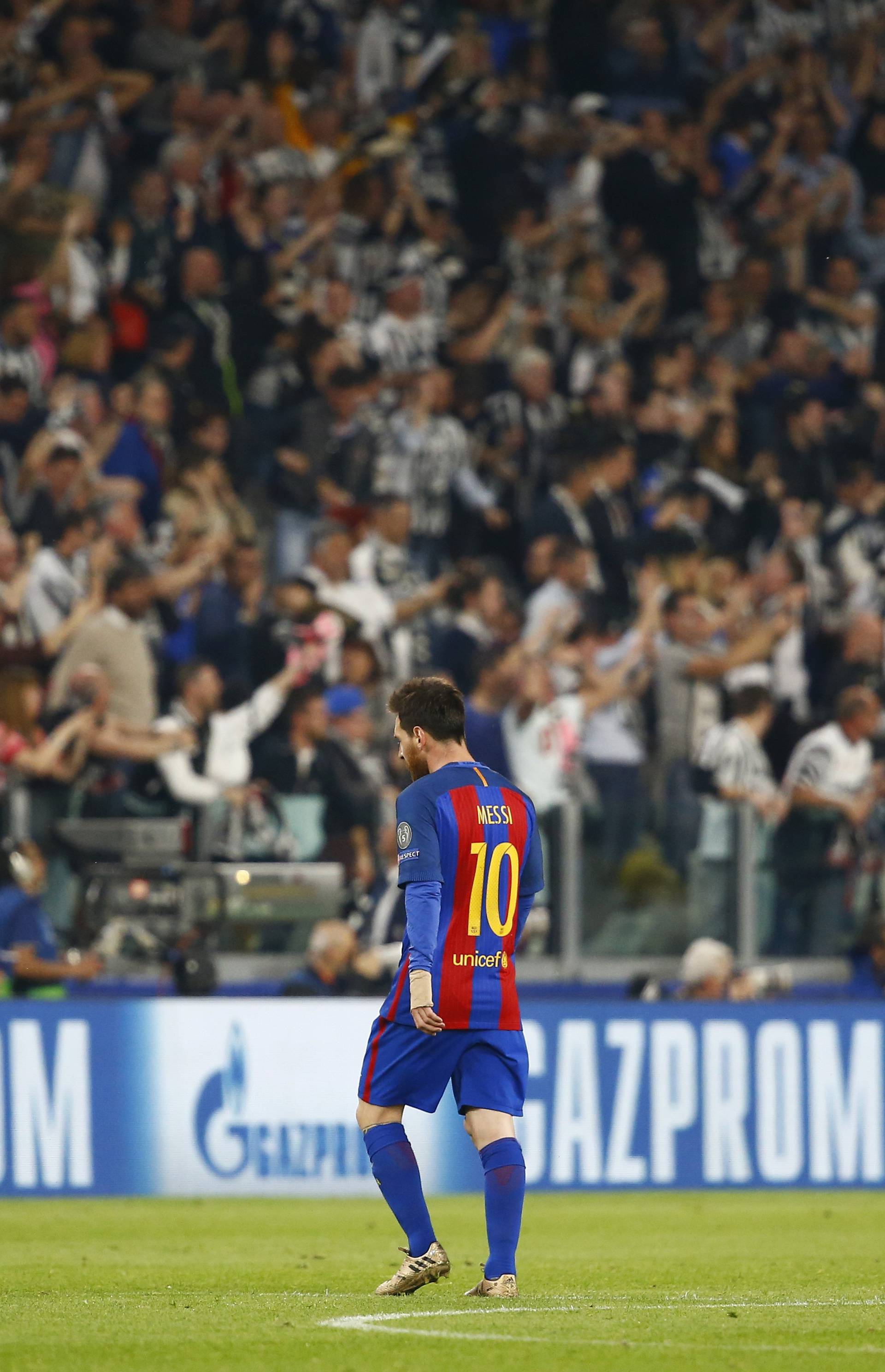 Barcelona's Lionel Messi looks dejected as Juventus fans celebrate