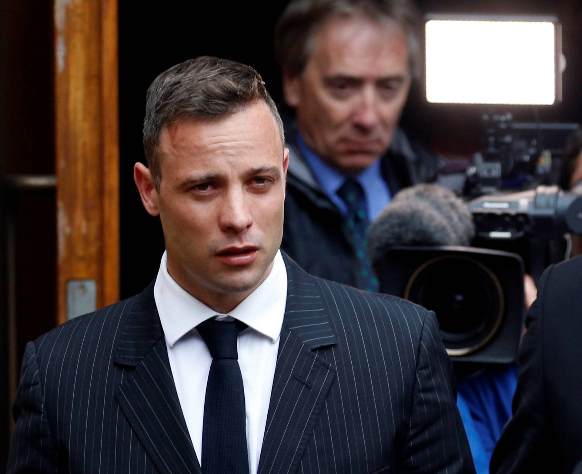 Former Paralympian Oscar Pistorius leaves during a court break at the Pretoria High Court