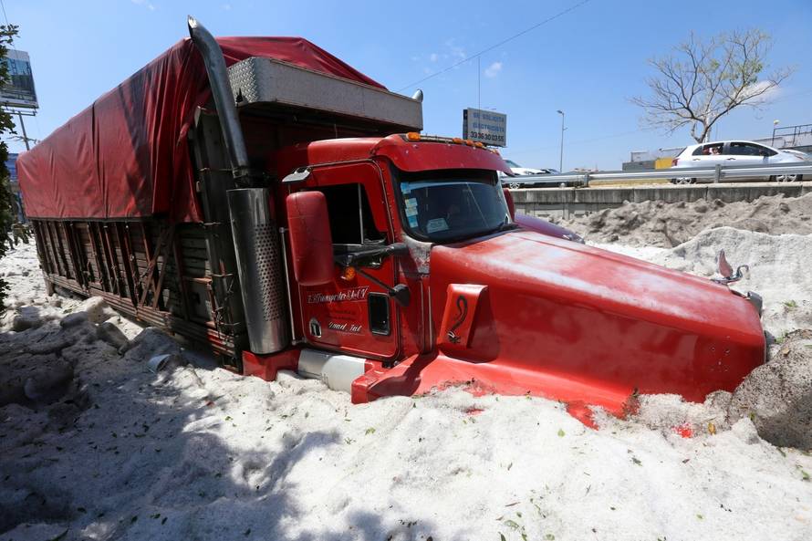 A truck is buried in ice after a heavy storm of rain and hail which  affected some areas of the city in ââGuadalajara