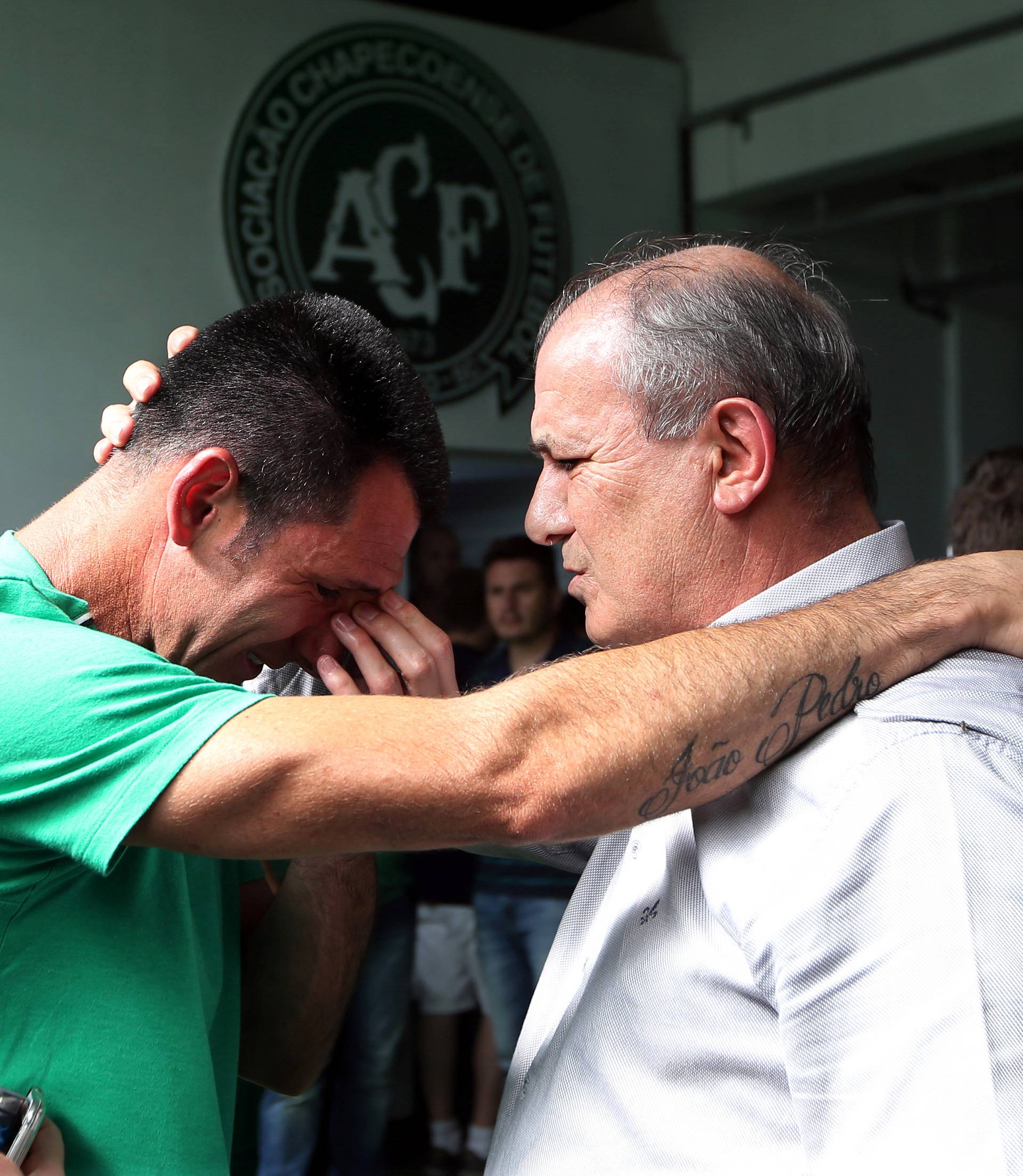 Chapecoense goalkeeper Jose Nivaldo reacts as he talks with Jose Tozzi, who became the team's acting president when his predecessor died in the crash in Chapeco