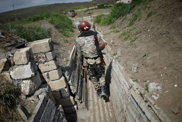 FILE PHOTO: Ethnic Armenian soldiers walk in a trench at their position near Nagorno-Karabakh