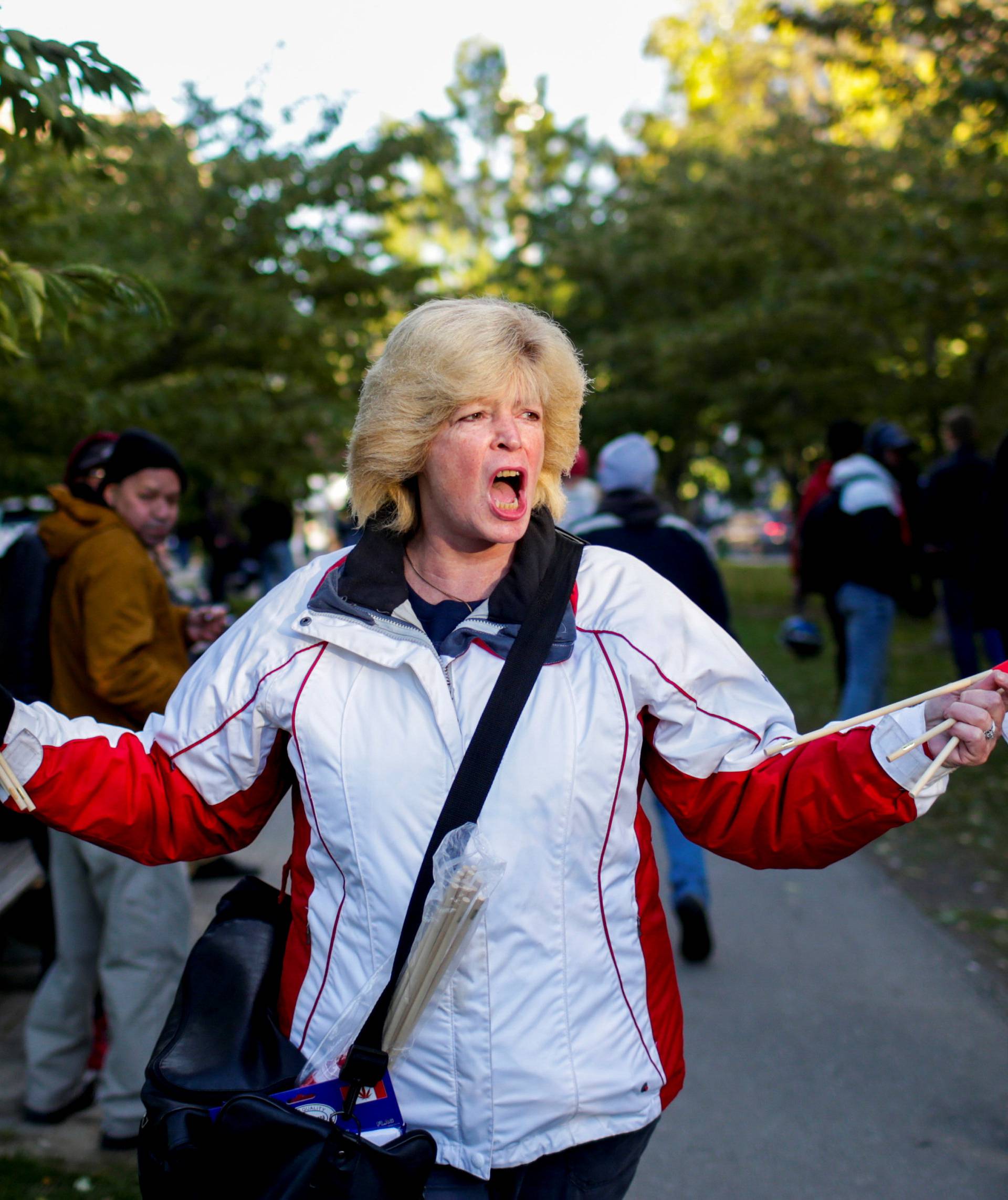 A woman waves flags on the day Canada legalizes recreational marijuana at Trinity Bellwoods Park