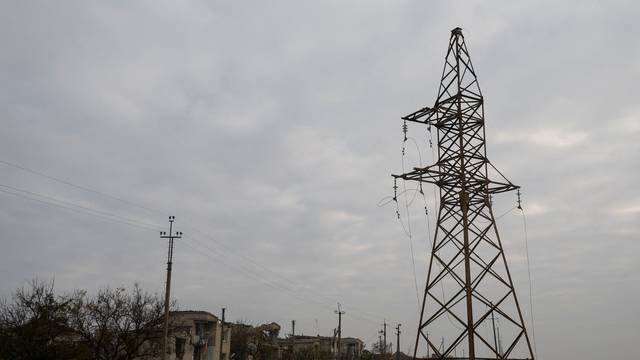 FILE PHOTO: Views shows houses and a pylon with high-voltage wires damaged during Russian military attacks in the village of Osokorivka, in Kherson region